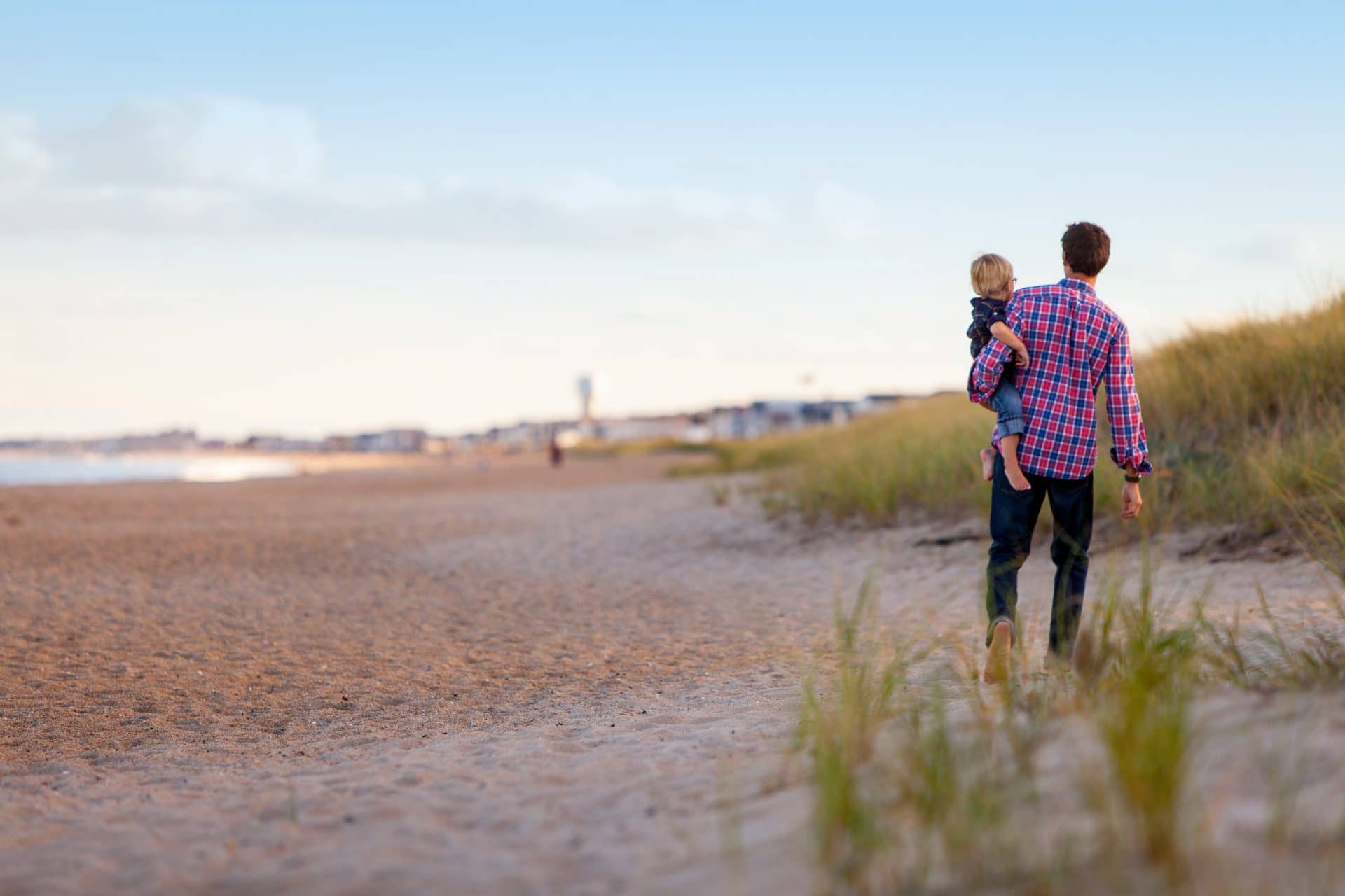 Father and son walking on the beach